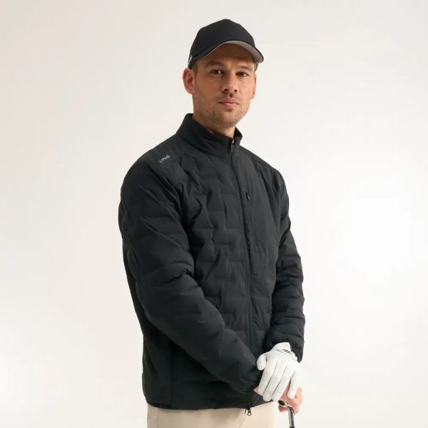 Golfer wearing the Ping Norse Cocoon 2.0 insulated jacket in black