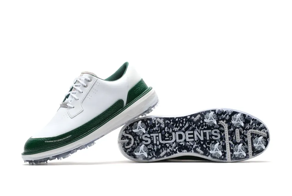 Students by PAYNTR WT golf shoe in white with green trim, shown with its Students-print outsole